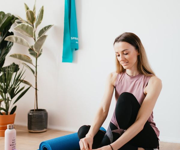 A cozy corner with a yoga mat and water bottle suggesting a daily routine.